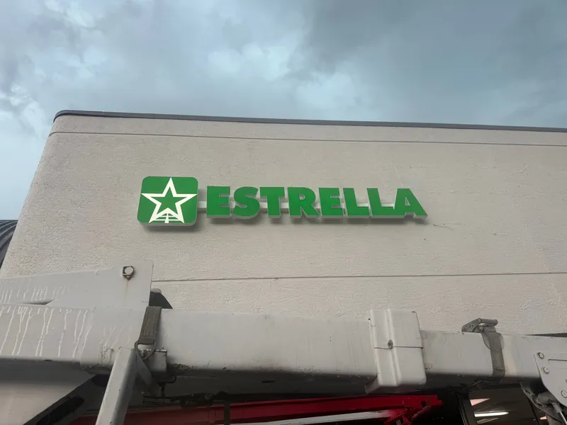 Green ESTRELLA channel letters with star logo on a Zephyrhills building, installed from our bucket truck